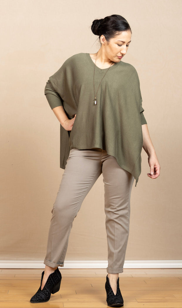 green boxy v-neck poncho-like sweater with 3/4 sleeves and side vents