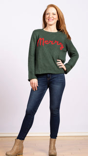 boxy pullover sweater in green with red lettering spelling Merry