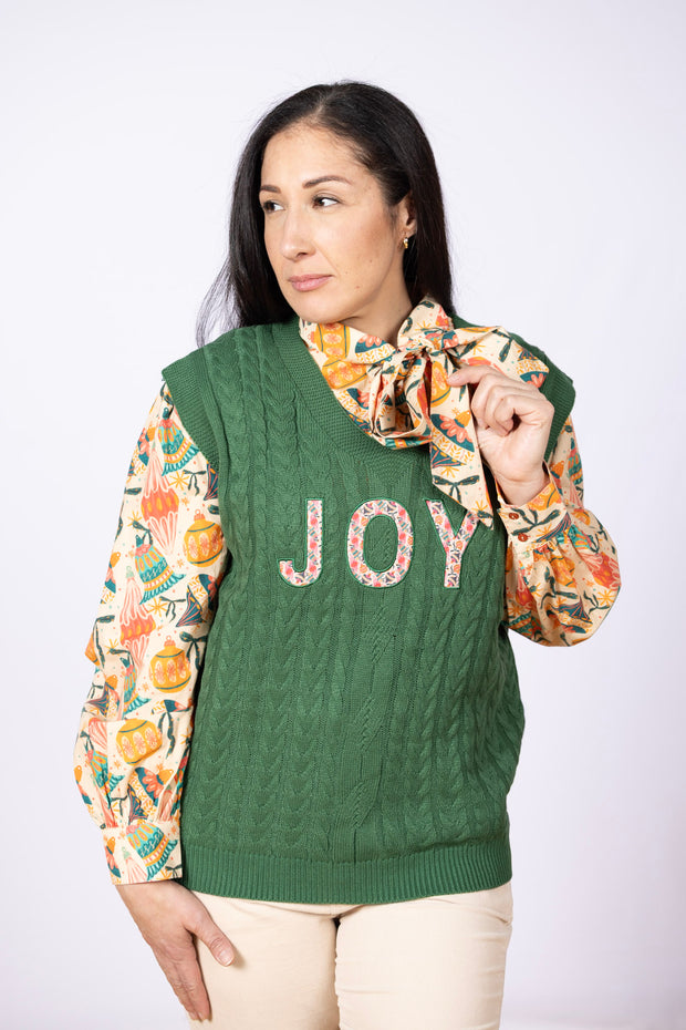 green vest with the word JOY on it
