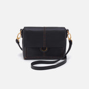 Black leather crossbody bag with gold accents and brown stitching